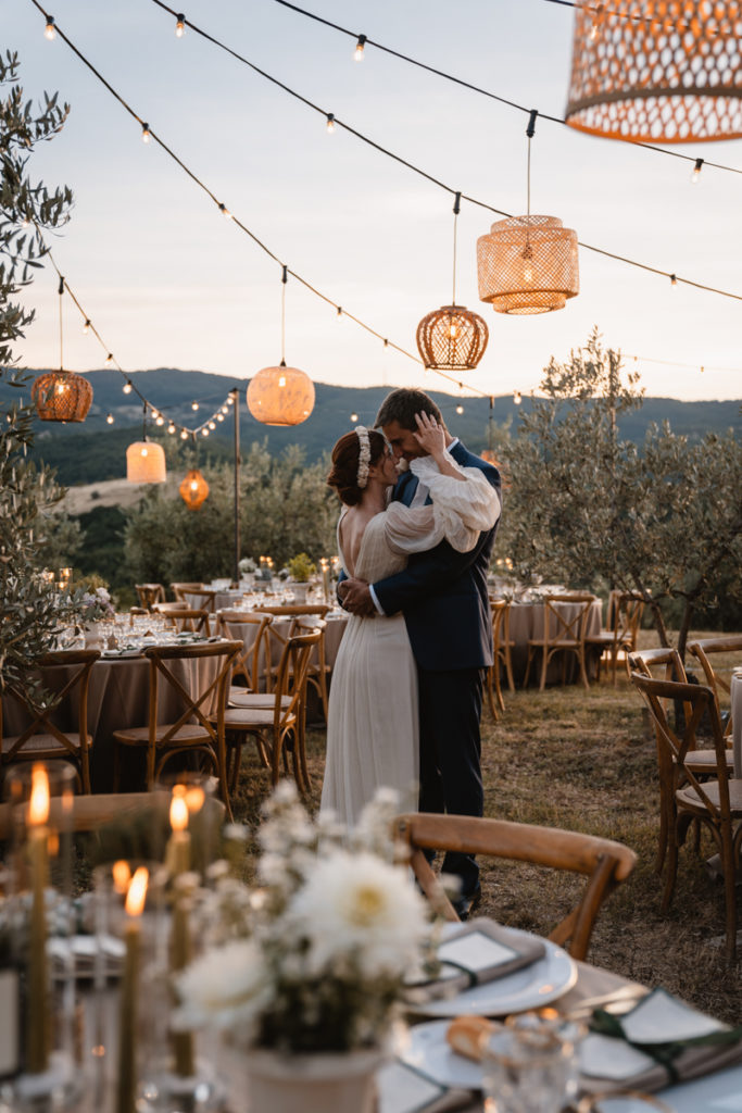 country, elegance, delicate, reportage, editorial, inspiration, real, venue, location, groom, dress, elegance, bouquet, stiatti, flowers, bride, crown, reportage, emotion, wedding, photographer, Umbria, italy, italian, style, sunset, photography, love, romantic, dinner, lights, table, catering, olives, trees