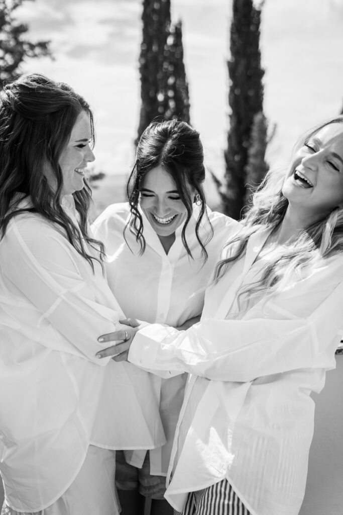 bride with her bridemaids smiling during getting ready