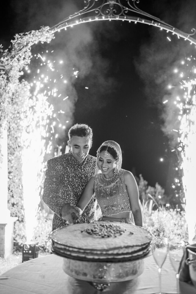 wedding cake in traditional indian wedding dress with firework
