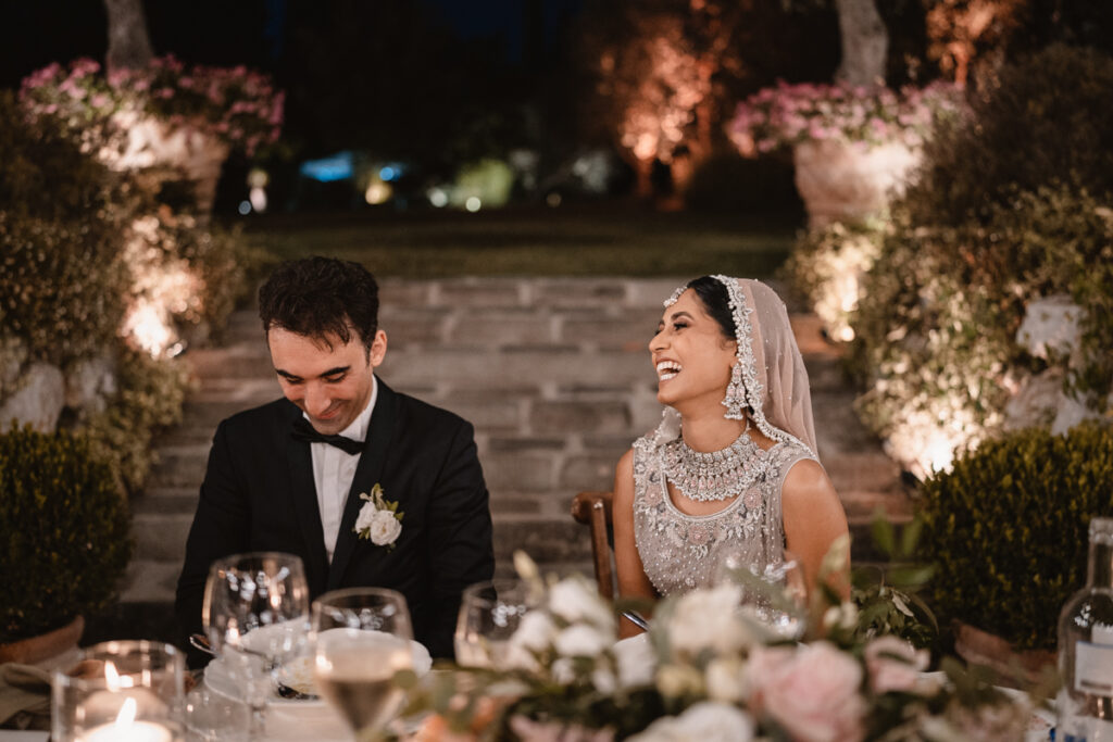 bride and groom during the dinner with candels and flowers