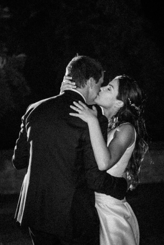 bride and groom kissing and dancing