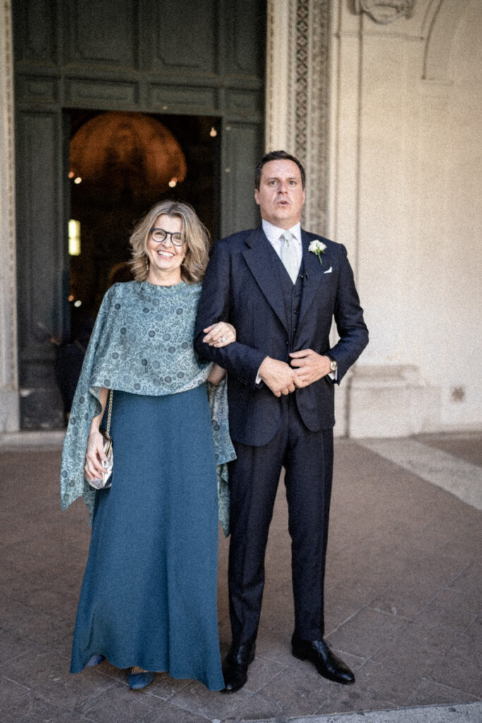 groom with his mom in front of the church before the ceromony